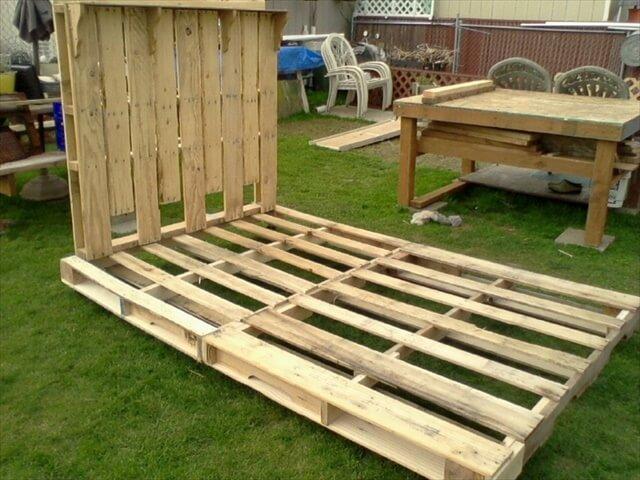 Bed Frame and headboard made from Pallets. The frame has hinges in the middle on
