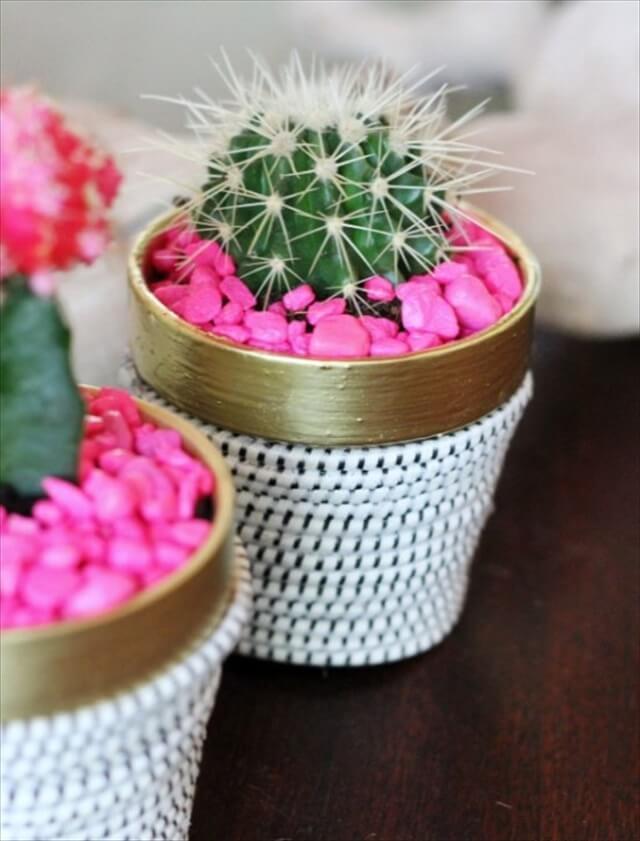 DIY succulent plant in terracotta pot wrapped in rope with hot pink aquarium rocks