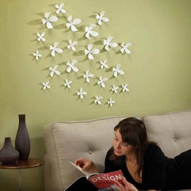 Add a nice and elegant feature to the room by decorating your wall with white flowers that can be easily made of paper. There are bunch of DIY articles