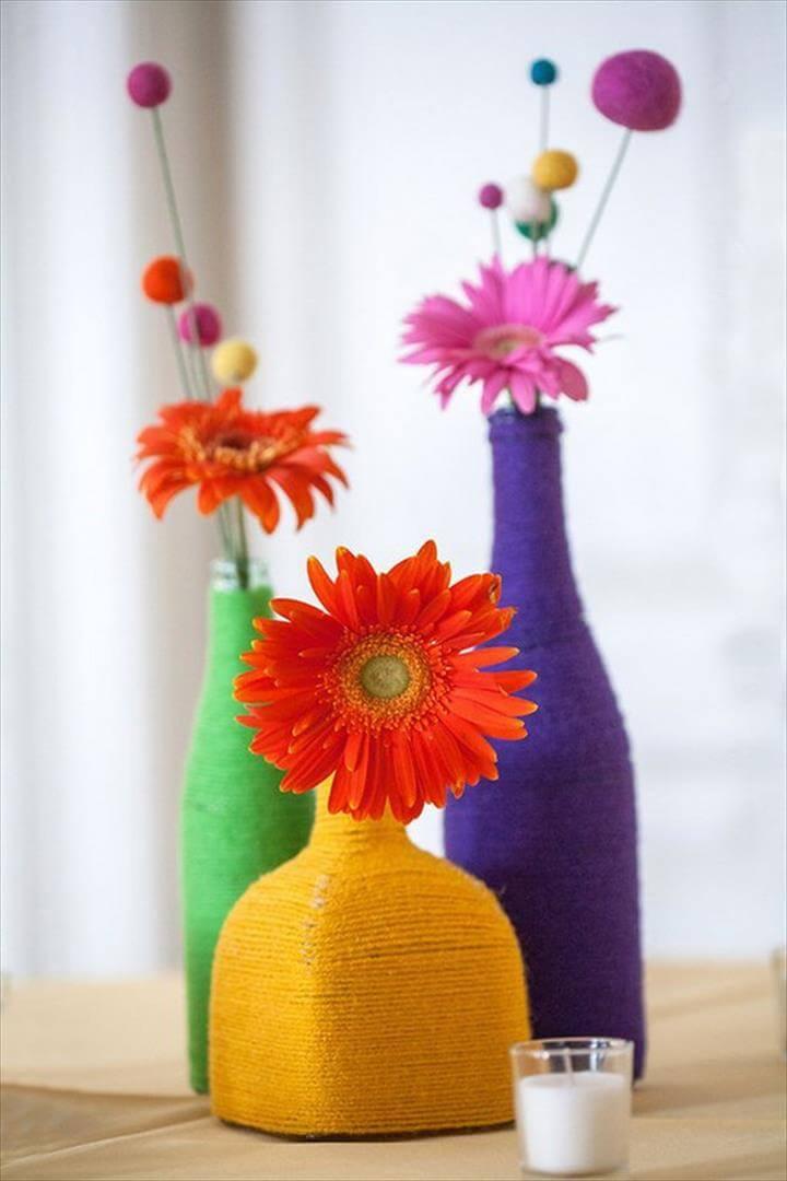 Yarn Wrapped Bottle.These wrapped bottles make simple and sweet centerpieces either on their own or with a few flowers tucked in!