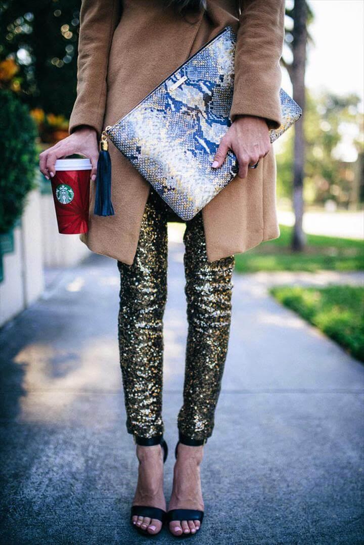 cool girl new year's eve outfit ideas - python clutch, camel coat + gold