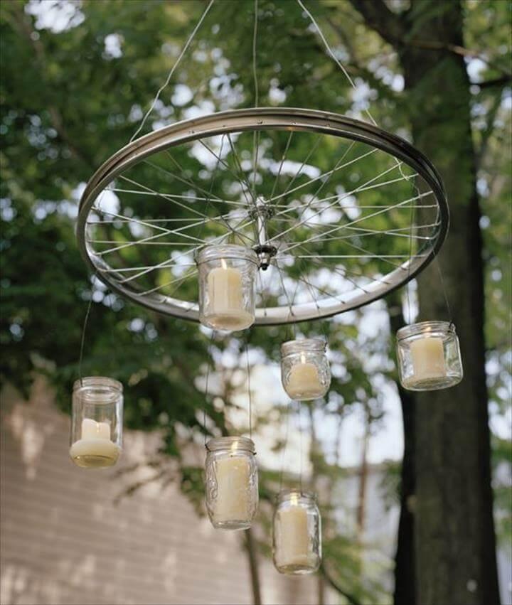 Bicycle Wheel. Hang glass jars with candles inside from a