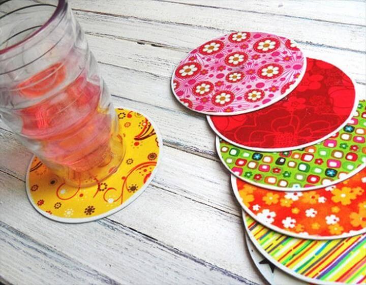 decorative coasters with colorful fabric pasted onto old CDs.