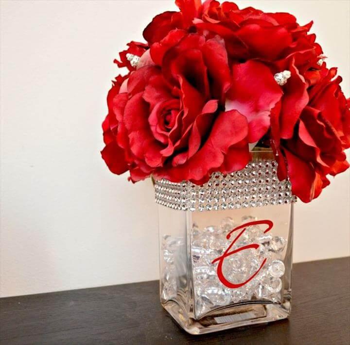 DIY centerpiece with small vases, large monogram stickers, pebbles, and carnations!