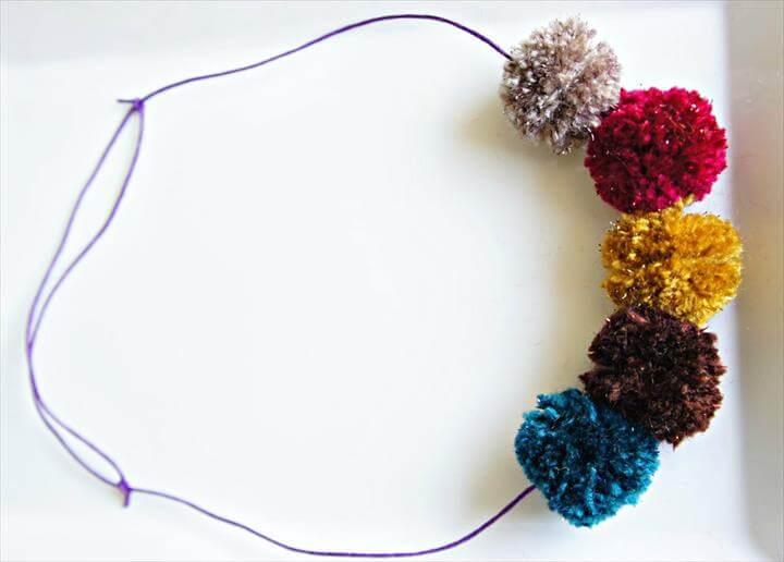 Sparkly pom poms on a slip necklace