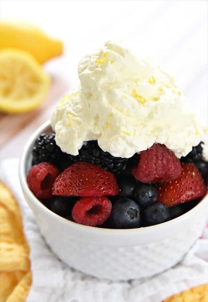 Lemon Whipped Cream Atop A Bowl Of Fresh Berries In a White Bowl